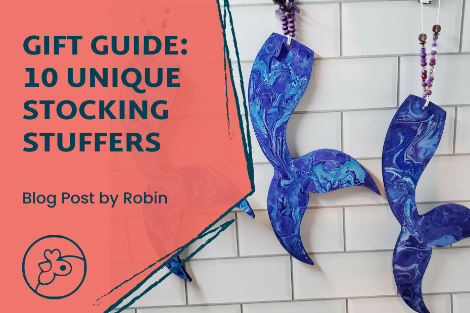 A photo of stylized mermaid tails that have beaded loops to hang them up with against a tile background. To the left, "Gift Guide: 10 unique stocking stuffers Blog Post by Robin" with the Artisans Cooperative chicken logo beneath.